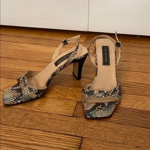Designer Halston leather sling back snakeskin sandals.  Sole is also leather.